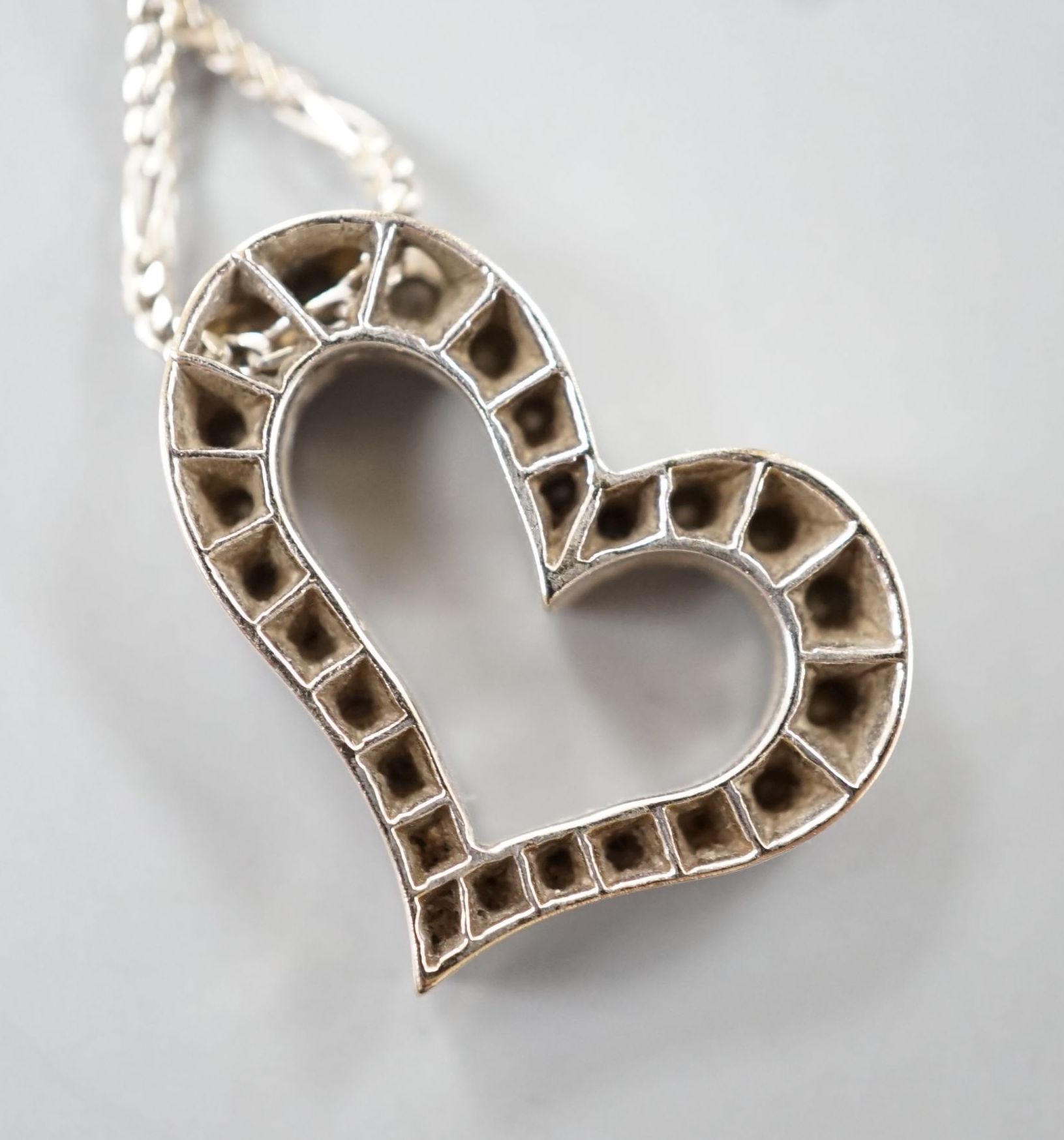 A modern 750 white metal and diamond set openwork heart pendant necklace, pendant width 22mm, chain, 40cm